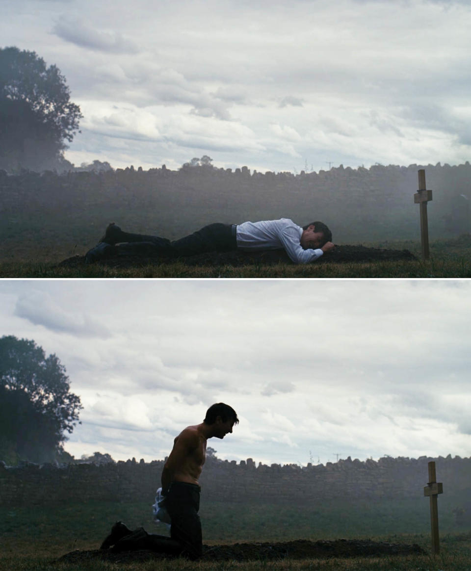 Oliver lying on top of a mound of dirt at Felix's grave