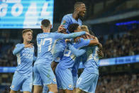Manchester City's Cole Palmer, right, is congratulated by teammates after scoring his team's fifth goal during the English League Cup third round soccer match between Manchester City and Wycombe Wanderers at Etihad Stadium, in Manchester England, Tuesday, Sept. 21, 2021. (AP Photo/Dave Thompson)