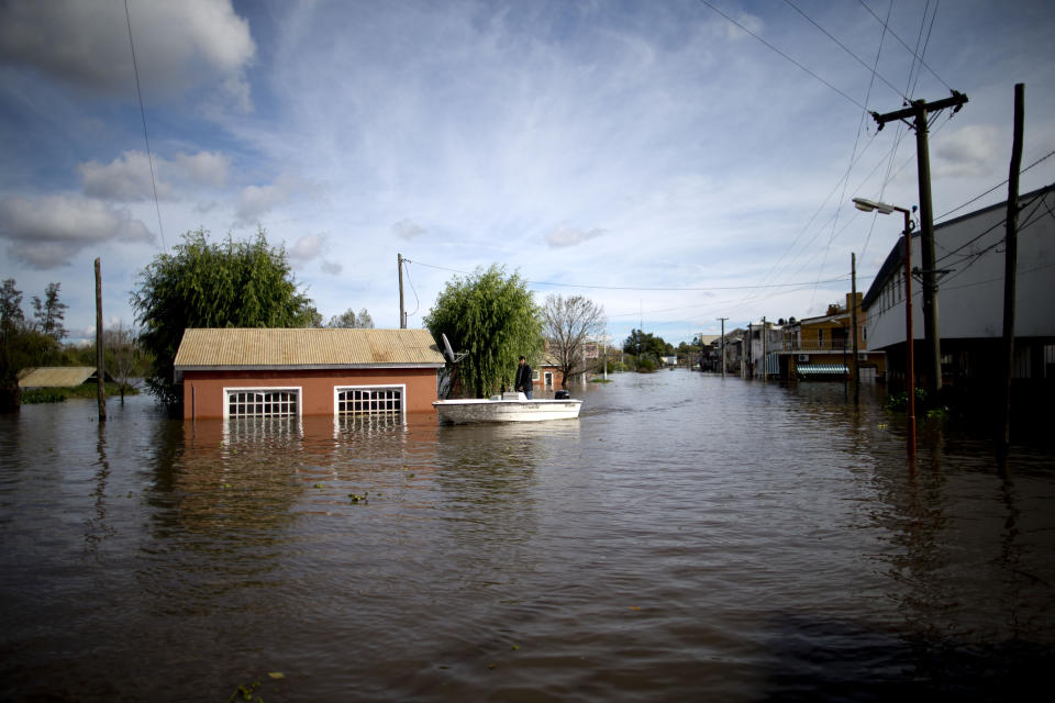 FILE - Roads are flooded in Villa Paranacito, Entre Rios, Argentina, Thursday, April 28, 2016. A new study Thursday, May 18, 2023, finds the natural burst of El Nino warming that changes weather worldwide is far costlier with longer-lasting expenses than experts had thought, averaging trillions of dollars in damage. (AP Photo/Natacha Pisarenko, File)