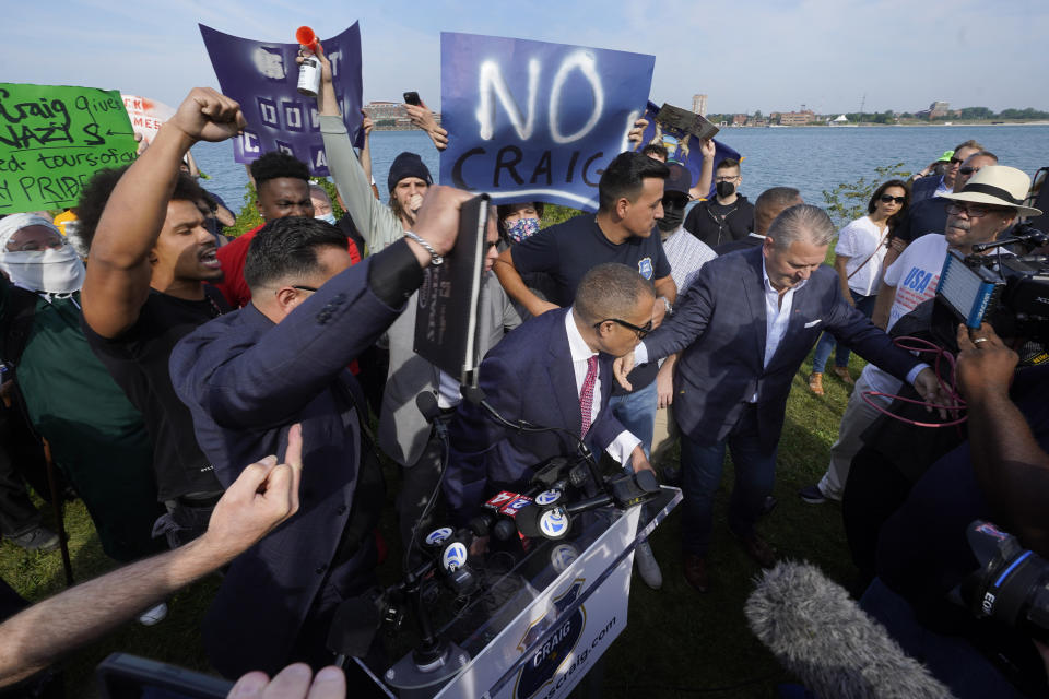 James Craig, a former Detroit Police Chief, leaves after announcing he is a Republican candidate for Governor of Michigan amongst protesters on Belle Isle in Detroit, Tuesday, Sept. 14, 2021. (AP Photo/Paul Sancya)