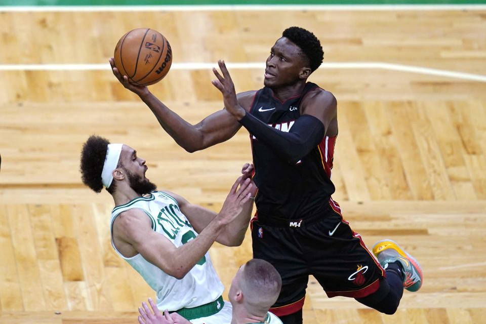 Miami Heat guard Victor Oladipo, right, is fouled by Boston Celtics guard Derrick White, left, on a drive to the basket during the first half of Game 4 of the NBA basketball playoffs Eastern Conference finals, Monday, May 23, 2022, in Boston. (AP Photo/Charles Krupa)