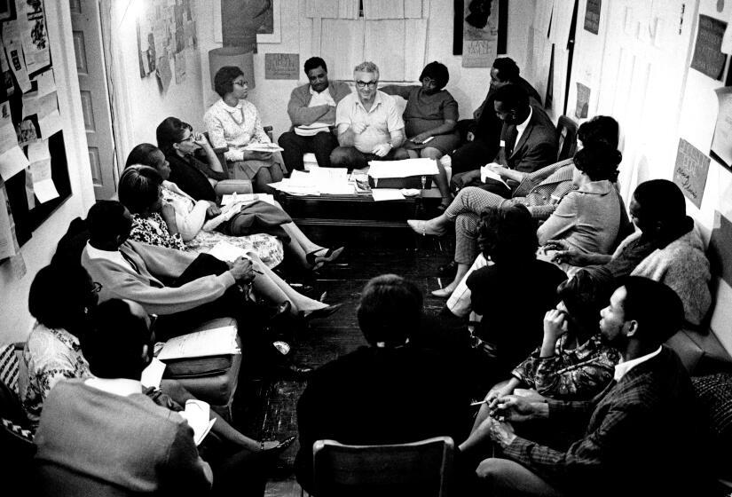 Novelist and screenwriter Budd Schulberg, center, began the Watts Writers Workshop in 1965. It was his personal effort at reconstruction after the Watts Riots. (Los Angeles Times)