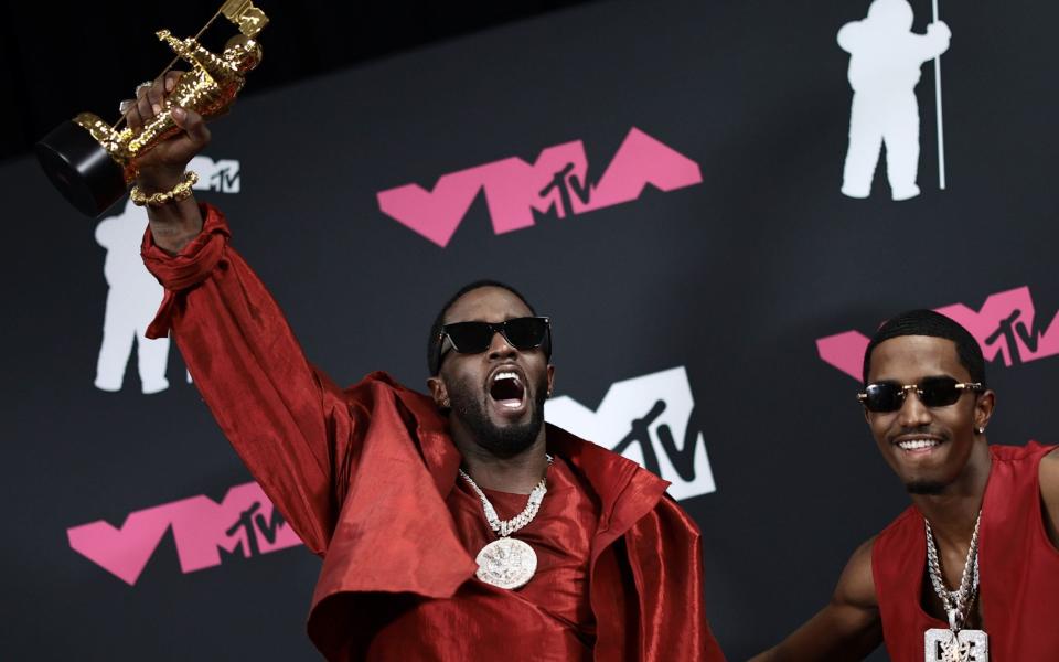 Diddy (left) poses in the press room with the Global Icon Award and his son King Combs (right) at the 2023 MTV Video Music Awards