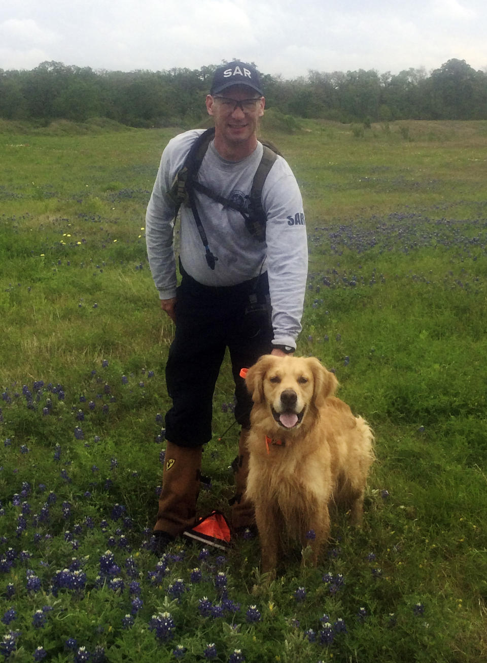 This April 2017 photo, provided by Jim Yeager, shows Robert Andrews and his golden retriever, Cooper, in College Station, Texas, as they completed a certification for search-and-rescue dogs. Cooper's brother Rainier is a show champion, a relationship that illustrates ties between show dogs and dogs that do specialized work. (Jim Yeager via AP)