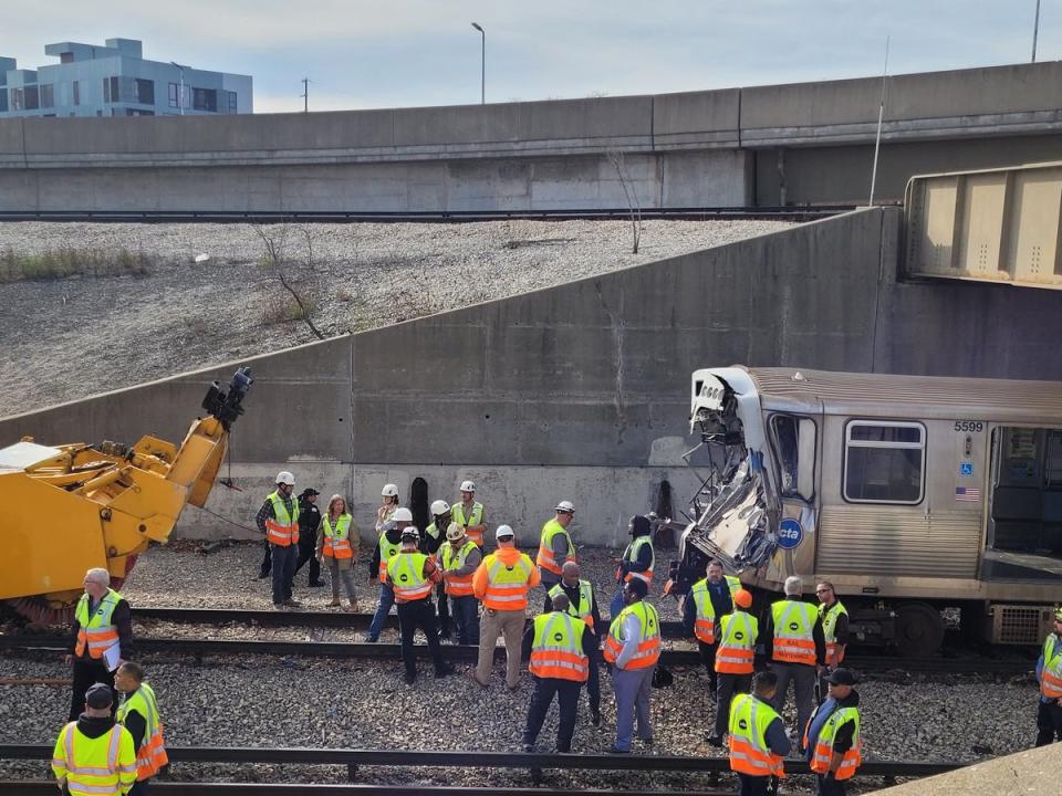 Workers examin the damage to a CTA train in Chicago, Illinois after it crashed into snow-removal equipment (Chicago Fire Department/AFP via)