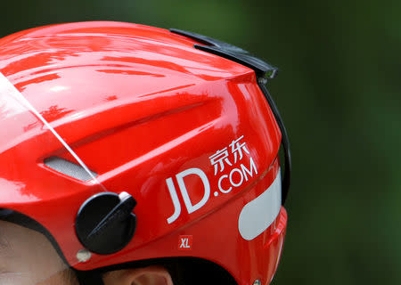 A logo of JD.com is seen on a helmet of a delivery man in Beijing, China June 16, 2014. Picture taken June 16, 2014. REUTERS/Jason Lee/File Photo