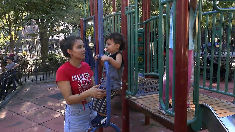 Diana Amezquita, from Bogota, Colombia, plays with her children at a playground on Manhattan's west side. - CNN