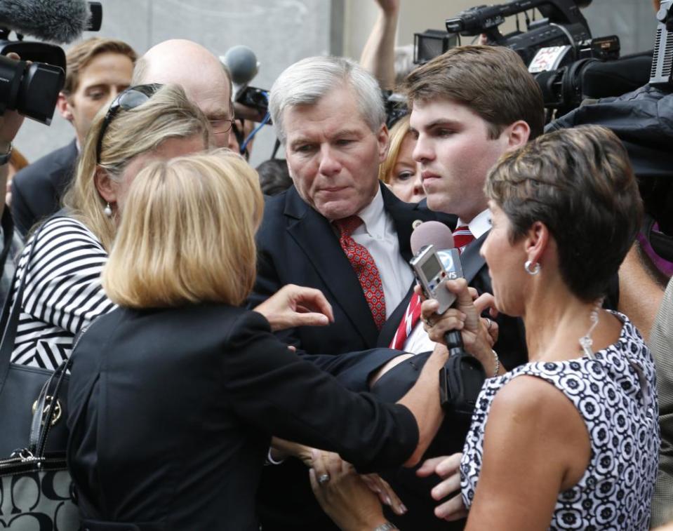 The former Virginia governor Bob McDonnell, center, is mobbed by media, friends and family after being convicted on multiple counts of corruption, in a 2014 photo. 