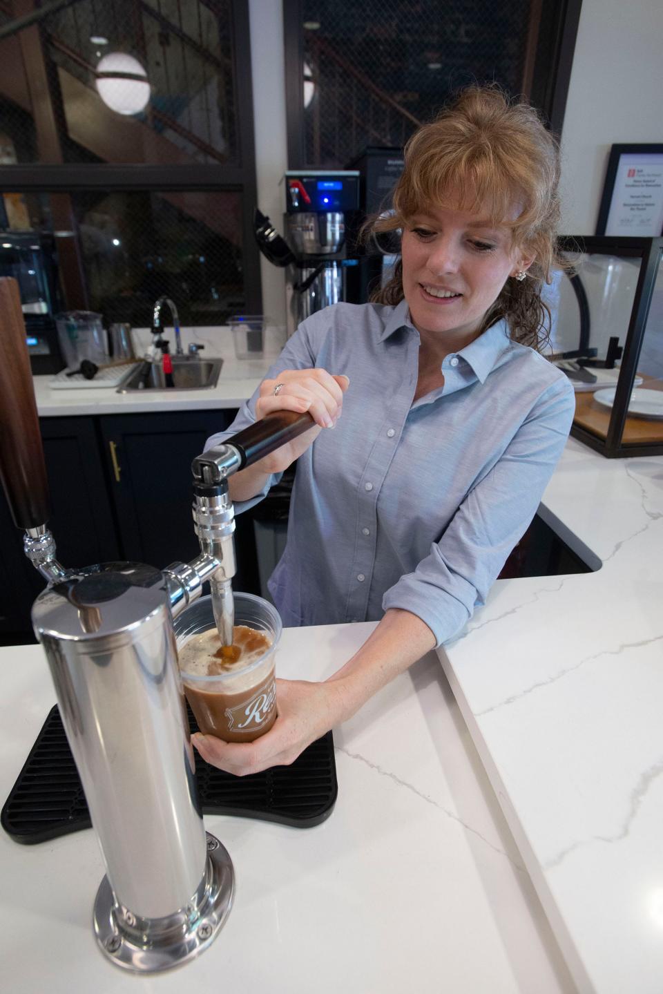 Assistant Manager Annie Gray pours a cold brew coffee drink Thursday at The Rex Café in downtown Pensacola.