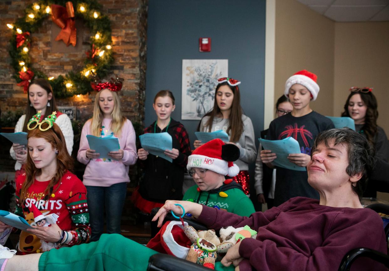 Cleo Butcher, of Chillicothe and a resident, listens as students from Zane Trace Middle School sing Christmas carols for the residents at Signature HealthCARE of Chillicothe on December 20, 2023, in Chillicothe, Ohio.