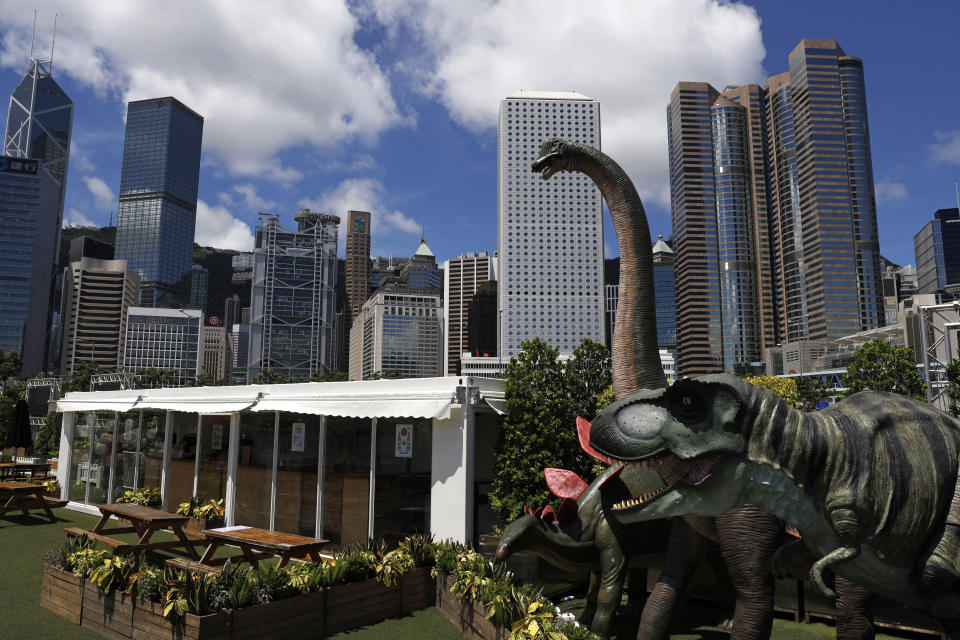 Dinosaur statues are displayed at the Central, a business district in Hong Kong, Saturday, June 20, 2020. China's top legislative body has taken up a draft national security law for Hong Kong that has been strongly criticized as undermining the semi-autonomous territory's legal and political institutions. (AP Photo/Kin Cheung)