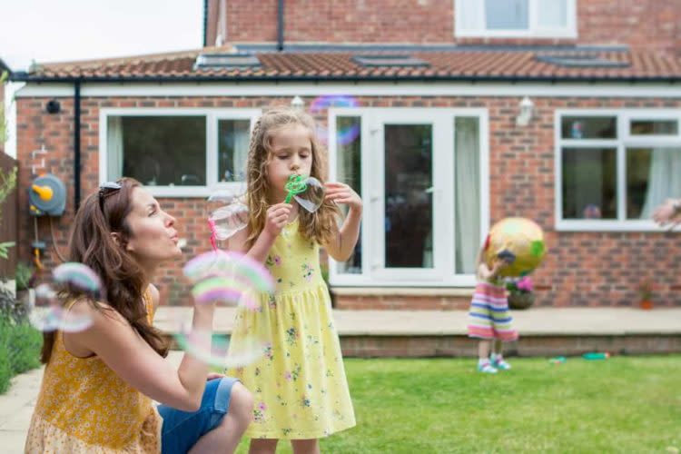 Mother and Daughter Blowing Bubbles