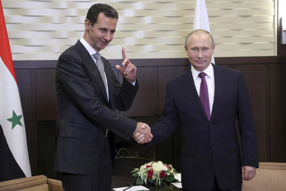 Russian President Vladimir Putin shakes hands with Syrian President Bashar Assad in the Bocharov Ruchei residence in the Black Sea resort of Sochi, Russia, Nov. 20, 2017. / Credit: AP