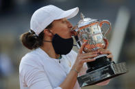 FILE - Poland's Iga Swiatek kisses the trophy after winning the final match of the French Open tennis tournament against Sofia Kenin of the U.S. in two sets, 6-4, 6-1, at the Roland Garros stadium in Paris, France, Saturday, Oct. 10, 2020. Swiatek was the 2020 champion at Roland Garros and was seeded No. 1 in the draw for this year’s tournament in Paris. (AP Photo/Christophe Ena, File)