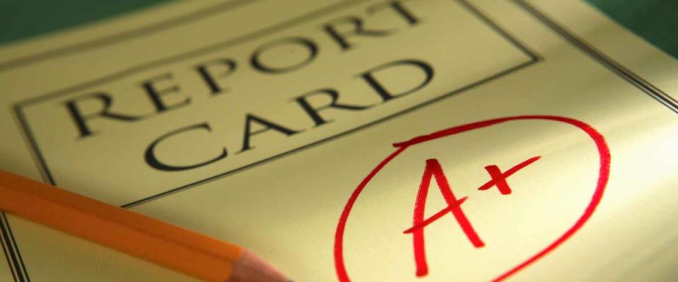 close up of report card with A+ and pencil