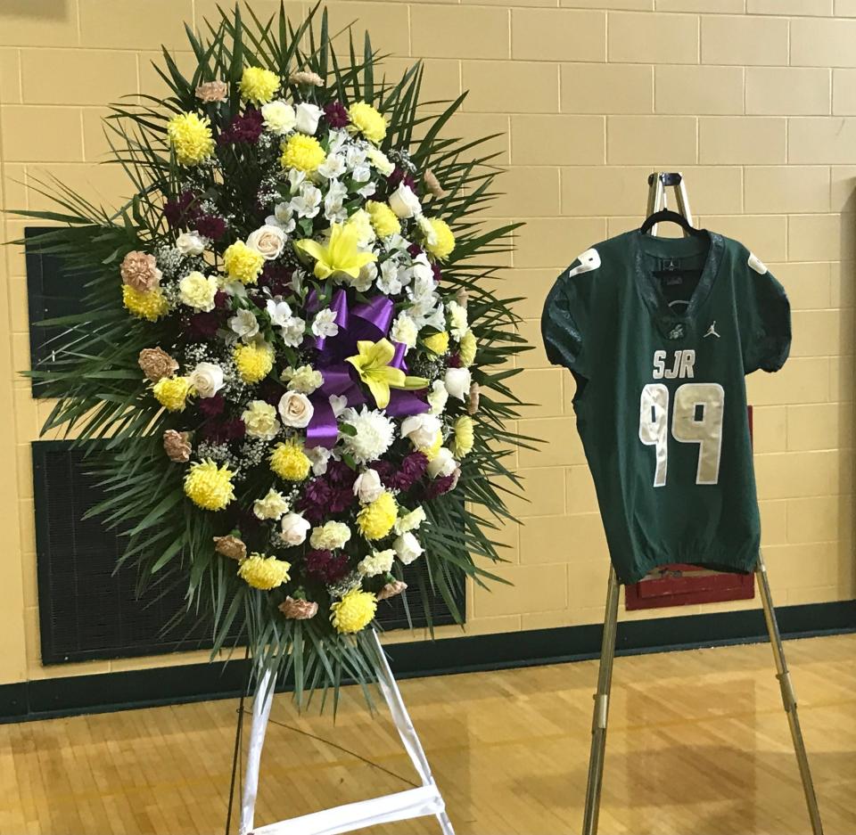 St. Joseph Regional High School in Montvale held a memorial service for 2021 graduate and former football player Cyrenius "Cy" Menard on Thursday, May 12, 2022. Alongside the floral arrangements, his No. 99 football jersey was on display.
