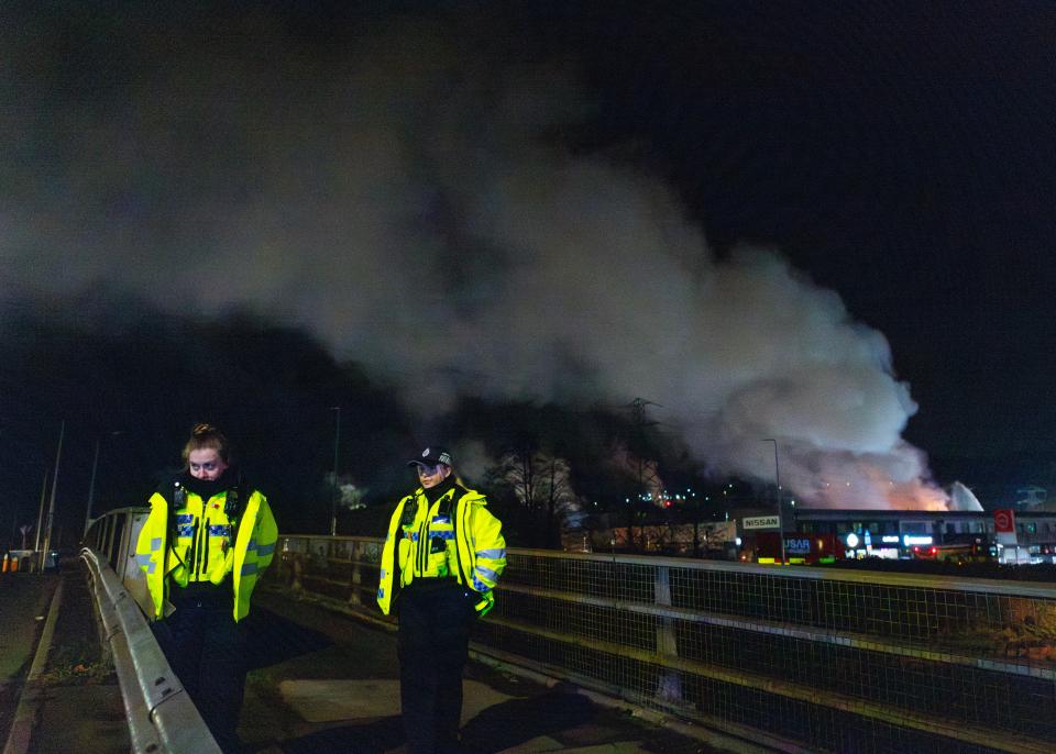 Police close roads near a fire at the Treforest Industrial Estate in Pontypridd, Wales, Britain, 14 December 2023 (EPA)