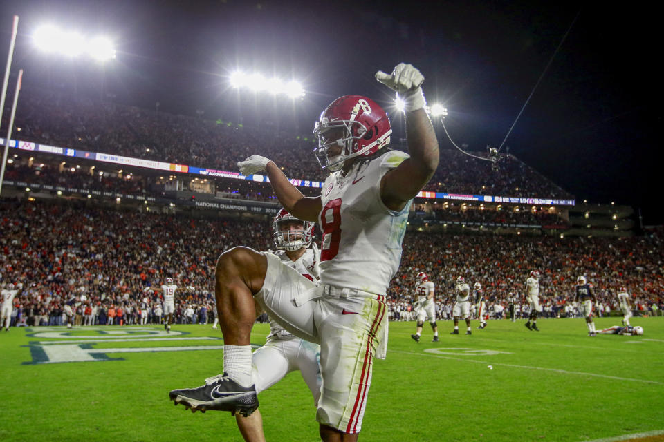 Alabama wide receiver John Metchie III (8) celebrates after scoring during the fourth overtime of an NCAA college football game to defeat Auburn 24-22 Saturday, Nov. 27, 2021, in Auburn, Ala. (AP Photo/Butch Dill)