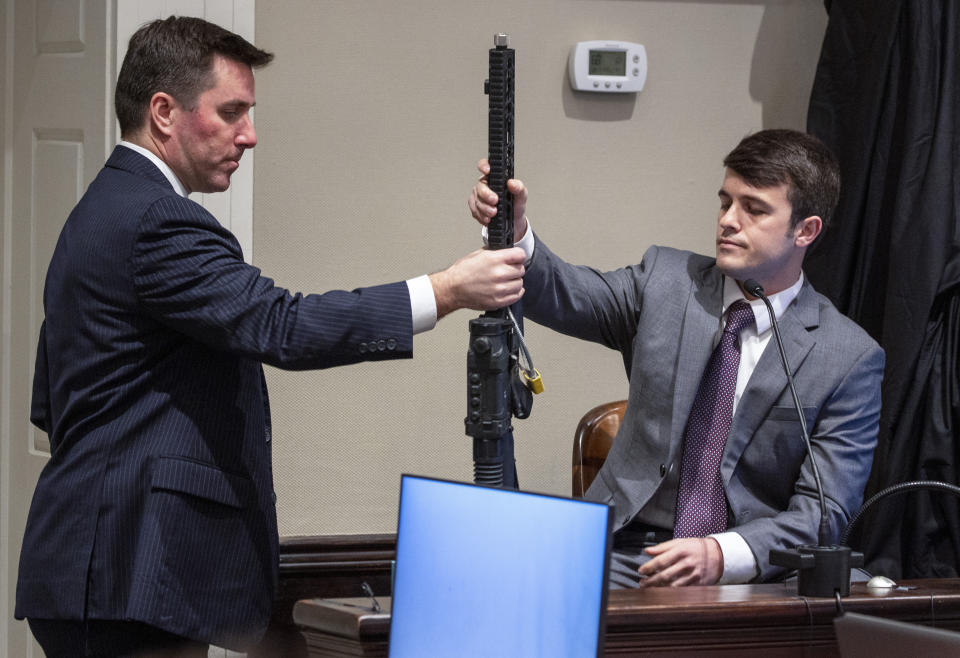 Assistant Deputy Attorney General David Fernandez, left, shows evidence to Nathan Tuten, a Murdaugh family friend, during Alex Murdaugh’s double murder trial at the Colleton County Courthouse on Friday, Feb. 10, 2023, in Walterboro, S.C. Murdaugh is standing trial on two counts of murder in the shootings of his wife and son at their Colleton County home and hunting lodge on June 7, 2021. (Andrew J. Whitaker/The Post And Courier via AP, Pool)