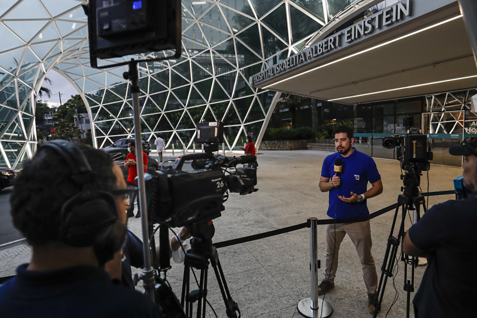 Media professionals work in front of the Albert Einstein Hospital where former soccer player Pele has been hospitalized since November 29, in Sao Paulo, Brazil, Tuesday, Dec. 27, 2022. (AP Photo/Marcelo Chello)