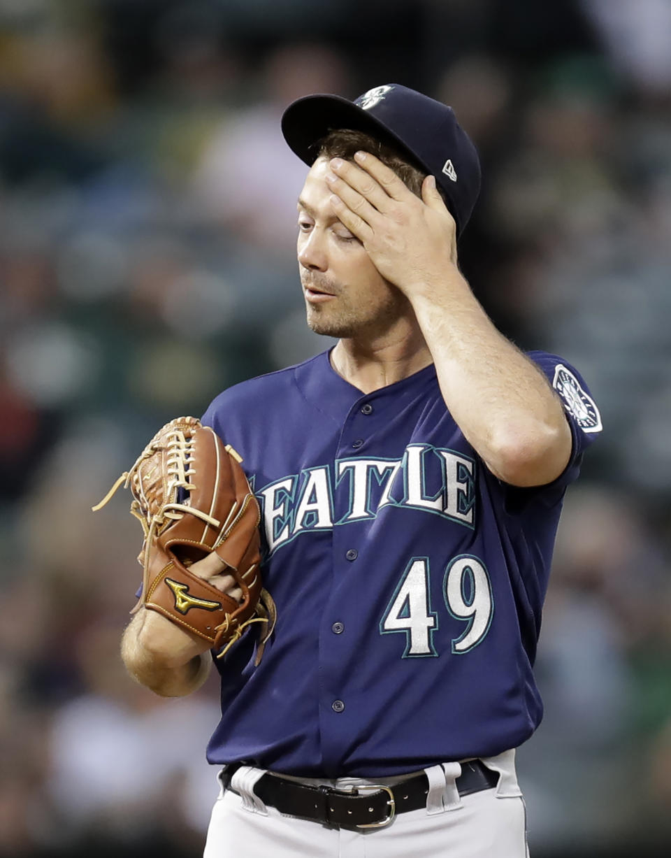 Seattle Mariners' Wade LeBlanc wipes his face in the fourth inning of a baseball game against the Oakland Athletics, Saturday, June 15, 2019, in Oakland, Calif. (AP Photo/Ben Margot)