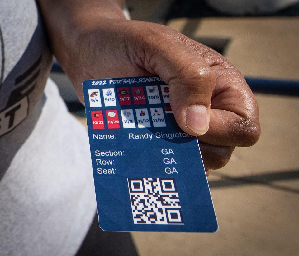 Rosie Singleton of Jackson, Miss., shows off her new Impact Ticket card for Jackson State University season tickets after waiting in line for about two hours at Mississippi Veterans Memorial Stadium to exchange the JSU Ticketmaster tickets for the new card Wednesday, Sept. 14, 2022.  JSU ended its contract with Ticketmaster.