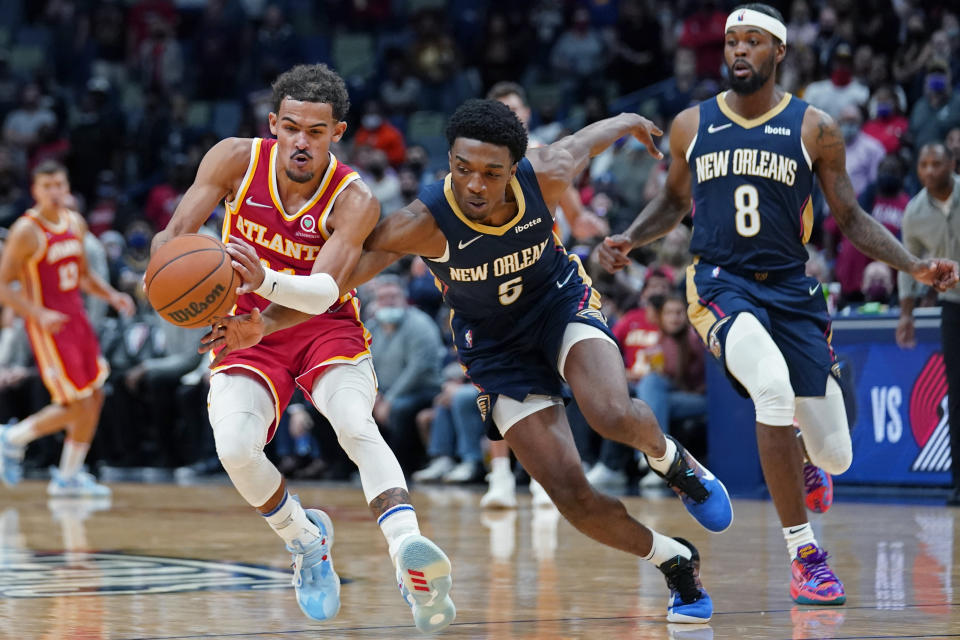 New Orleans Pelicans forward Herbert Jones (5) fouls Atlanta Hawks guard Trae Young as he chases down an inbound pass in the final seconds of the second half of an NBA basketball game in New Orleans, Wednesday, Oct. 27, 2021. The Hawks won 102-99. (AP Photo/Gerald Herbert)