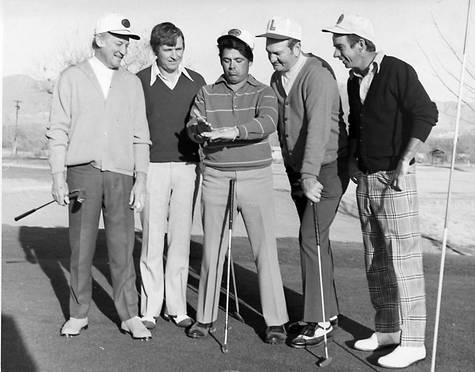 Golf great Lee Trevino, center, flips a coin to decide which team will do what in the Sun Bowl in December 1971 between Louisiana State University and Iowa State University. He played a round of golf earlier that week at the El Paso Country Club with, from left, Frank Redman, ISU coach Johnny Majors, LSU coach Charlie McClendon and country club golf pro Bill Eschenbrenner.