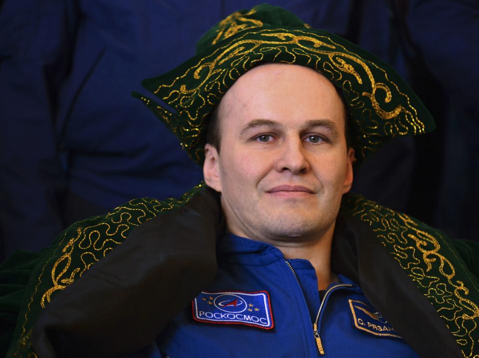 Flight engineer Sergei Ryazansky of Russia attends a news conference, wearing a traditional Kazakh hat and costume, in Karaganda, March 11, 2014. An American astronaut and two Russians who carried a Sochi Olympic torch into open space landed safely and on time on Tuesday in Kazakhstan, defying bad weather and ending their 166-day mission aboard the International Space Station (ISS). Inside the capsule were former ISS commander Oleg Kotov and flight engineers Ryazansky and Michael Hopkins from NASA. The trio launched together into space on September 25. REUTERS/Vasily Maximov/Pool (KAZAKHSTAN - Tags: TRANSPORT HEADSHOT SCIENCE TECHNOLOGY)