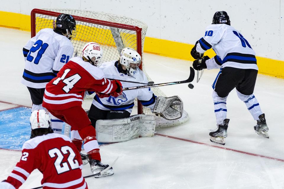 Oyster River goalie Cole Harwood looks for the puck during Saturday's Division II state championship game at Southern New Hampshire University Arena in Manchester.