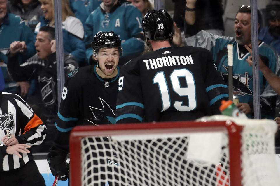 San Jose Sharks center Tomas Hertl, left, celebrates after scoring a goal against the Vancouver Canucks with center Joe Thornton (19) during the first period of an NHL hockey game in San Jose, Calif., Saturday, Dec. 14, 2019. (AP Photo/Jeff Chiu)