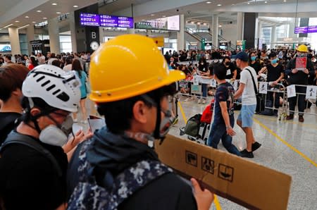 Anti-extradition bill protesters attend a mass demonstration after a woman was shot in the eye during a protest at Hong Kong International Airport, in Hong Kong