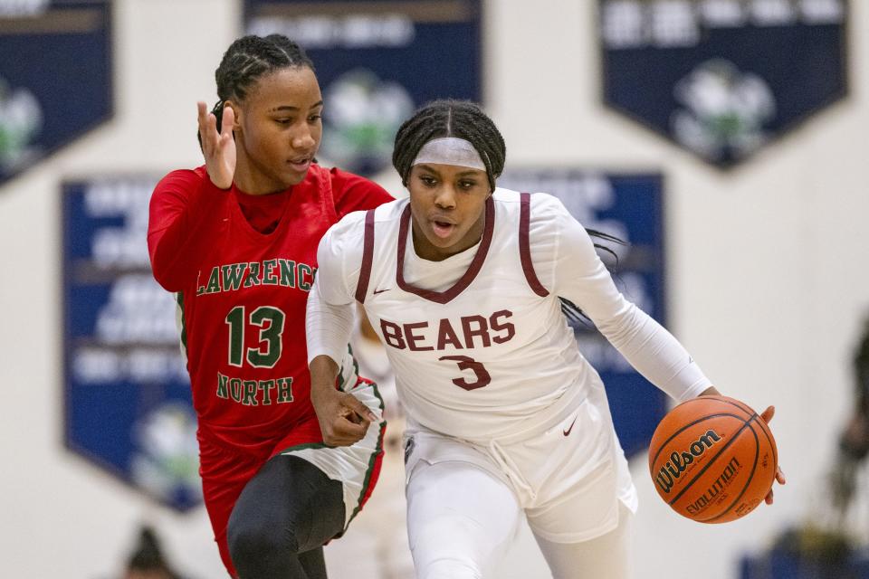 Lawrence North High School sophomore Naja Winston (13) guards Lawrence Central High School sophomore Lola Lampley (3) as she brings the ball up court during the first half of an IHSAA Class 4A Sectional semi-final basketball game, Friday, Feb. 2, 2024, at Cathedral High School.