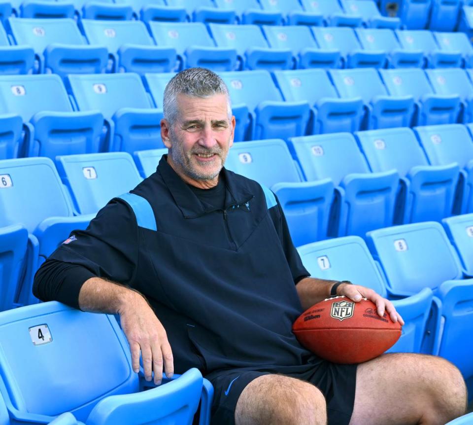 New Carolina Panthers head coach Frank Reich, sitting in the stands at Bank of America Stadium in August 2023, makes his debut for the team in a road game against Atlanta Sept. 10th. In another game at Atlanta, in 1995, Reich led the Panthers in their first-ever game -- but that time as the team’s quarterback.