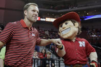 In this Wednesday, Oct. 30, 2019 photo, Nebraska coach Fred Hoiberg is greeted by mascot Herbie Husker, before an NCAA college basketball exhibition game against Doane University in Lincoln, Neb. Hoiberg knows the track record of Nebraska basketball coaches is not good. He wanted the job anyway. He takes over a program that has not won a conference championship in 70 years or ever won a game in the NCAA Tournament. He says a sold-out arena and top-notch facilities can trump the program's lack of tradition. (AP Photo/Nati Harnik)