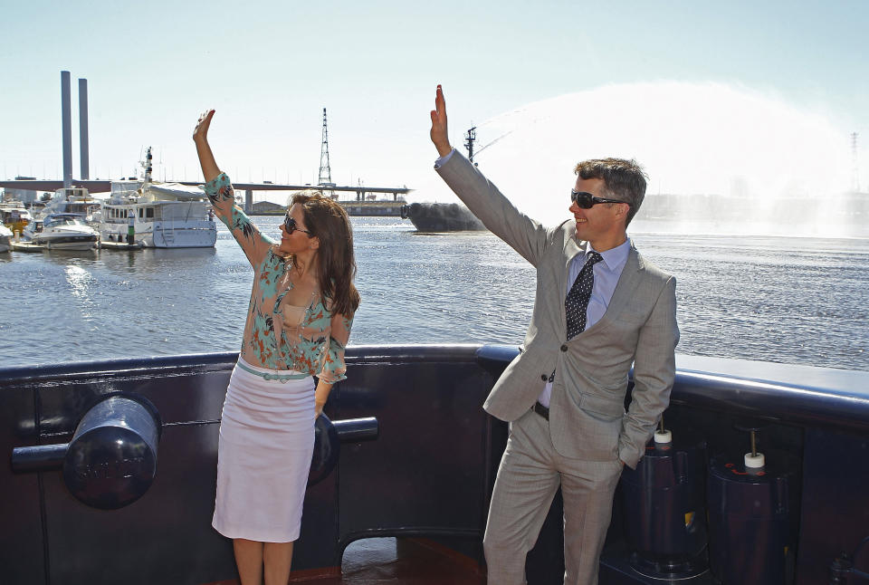 FILE - Denmark's Crown Prince Frederik and Crown Princess Mary wave from the tugboat "Svitzer Marysville" during its naming ceremony in Melbourne, Australia, Thursday, Nov 24, 2011. As a teenager, Crown Prince Frederik felt uncomfortable being in the spotlight, and pondered whether there was any way he could avoid becoming king. All doubts have been swept aside as the 55-year-old takes over the crown on Sunday, Jan. 14, 2024 from his mother, Queen Margrethe II, who is breaking with centuries of Danish royal tradition and retiring after a 52-year reign.(Scott Barbour, Pool Photo via AP, File)