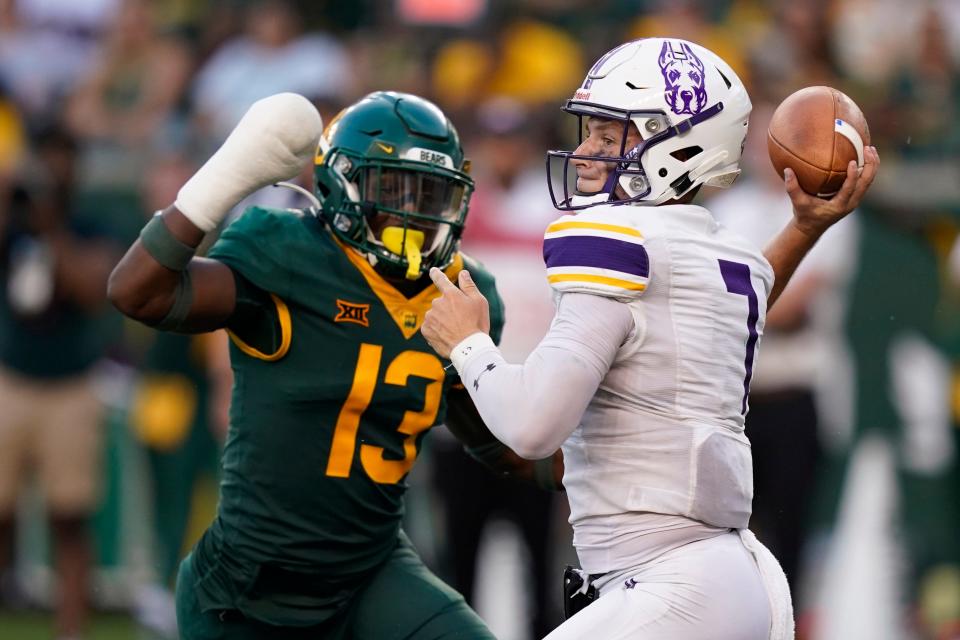 Albany quarterback Reese Poffenbarger, shown in action against Baylor last season, threw for 324 yards and four touchdowns against Rhode Island on Saturday.