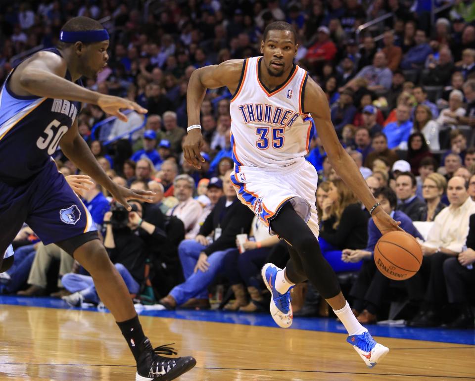 Memphis Grizzlies forward Zach Randolph (50) defends as Oklahoma City Thunder forward Kevin Durant (35) drives to the basket during the third quarter of an NBA basketball game on Monday, Feb. 3, 2014, in Oklahoma City. Oklahoma City won 86-77. (AP Photo/Alonzo Adams)