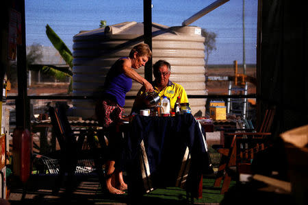 Local residents Judy and Jeff Baldry prepare to eat breakfast at their property, in the outback town of Stonehenge, in Queensland, Australia, August 13, 2017. REUTERS/David Gray