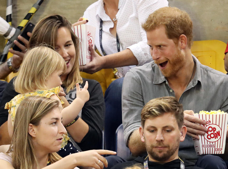 <p>On Wednesday in Toronto, Prince Harry teases athlete David Henson's daughter Emily, 2, as she and mom Hayley watch the sitting volleyball finals at the Invictus Games. </p>