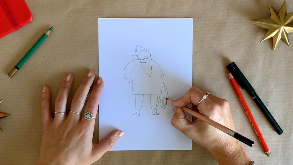 illustrator drawing santa's sack and presents with a pencil