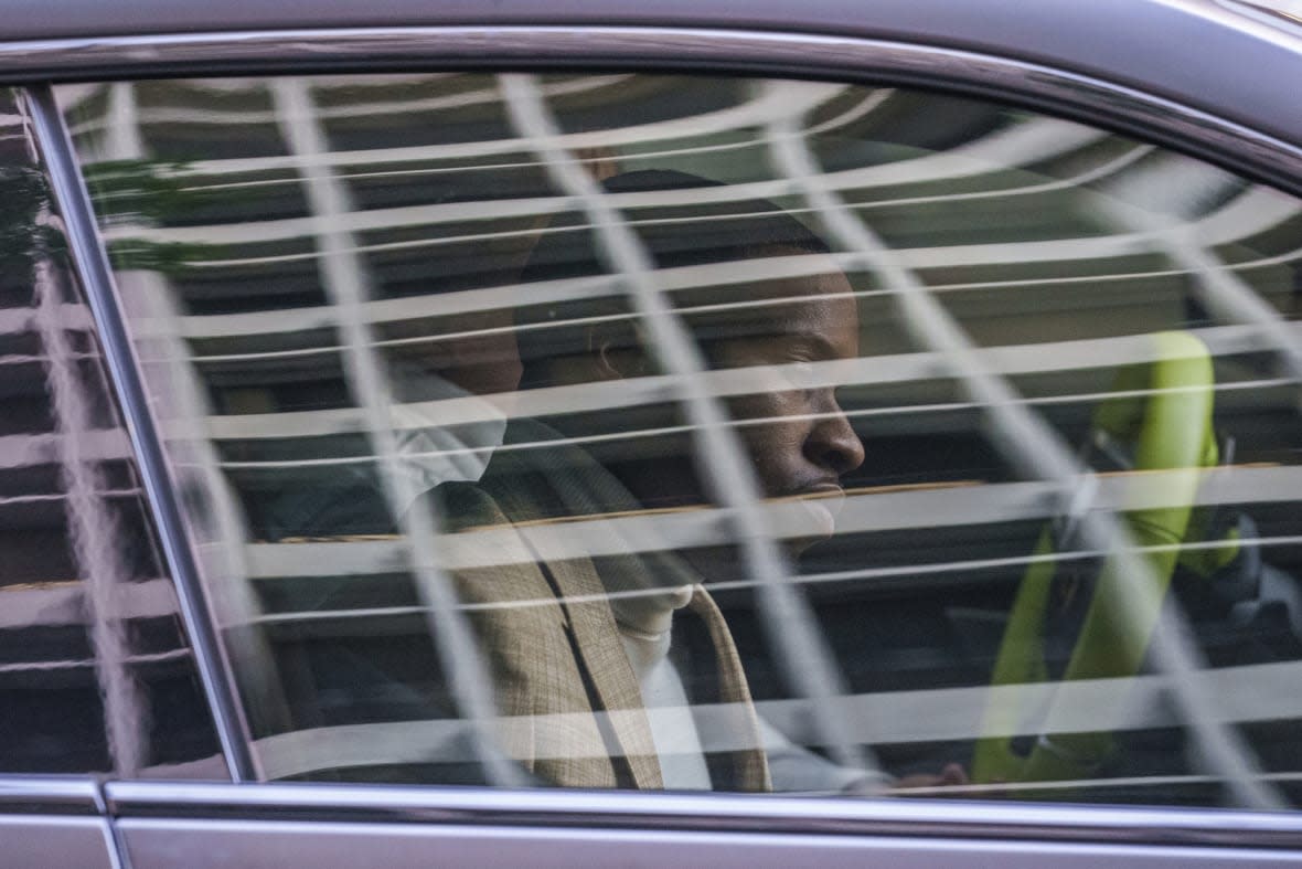 Daystar Peterson, the rap artist known as Tory Lanez, 30, sits in the passenger seat of a sport car as he’s driven away from the Clara Shortridge Foltz Criminal Justice Center Tuesday, Dec. 13, 2022, in Los Angeles. (AP Photo/Damian Dovarganes)