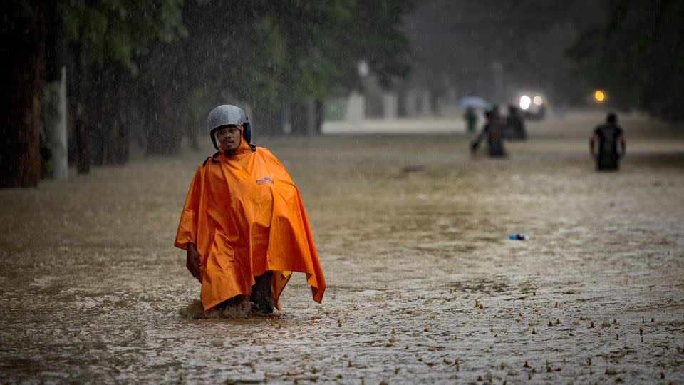 Residents wade in a flooded road caused by Typhoon Gaemi and monsoon rains on July 24, 2024 in Marikina, Metro Manila, Philippines. - Ezra Acayan/Getty Images