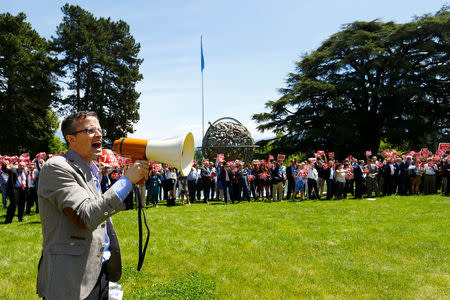Daniel Cork, head of the International Labour Organization (ILO) staff union, shouts slogan towards United Nations and other agencies staff during a demonstration against a planned 7,5 % salary cut at the U.N. in Geneva, Switzerland, May 24, 2017. REUTERS/Denis Balibouse