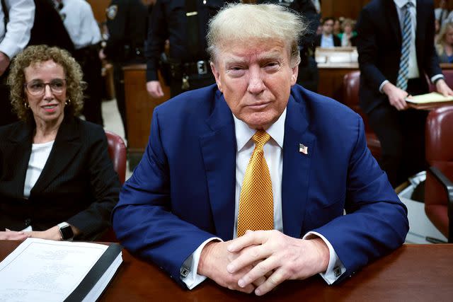 <p>WIN MCNAMEE/POOL/AFP via Getty Images</p> Donald Trump, accompanied by attorney Susan Necheles, prepares for the first day of Stormy Daniels' testimony in his Manhattan criminal trial on Tuesday, May 7