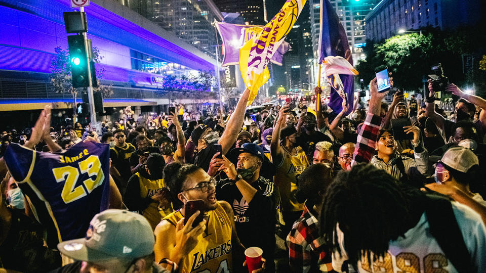 Pictured here, a huge gathering of fans celebrate the Lakers' NBA title outside Staples Center.