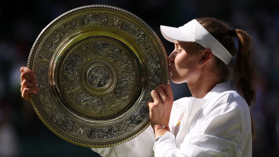 LONDON, ENGLAND - JULY 09: Elena Rybakina of Kazakhstan kisses the trophy after victory against Ons Jabeur of Tunisia during the Ladies' Singles Final match on day thirteen of The Championships Wimbledon 2022 at All England Lawn Tennis and Croquet Club on July 09, 2022 in London, England. (Photo by Clive Brunskill/Getty Images) - Clive Brunskill/Getty Images Europe/Getty Images