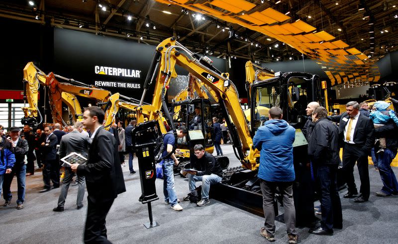 FILE PHOTO: People visit the Caterpillar stand at the 'Bauma' Trade Fair in Munich