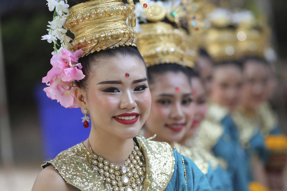 Thai tradition dancers prepare before a religious ceremony near the Tham Luang cave in Mae Sai, Chiang Rai province, Thailand Monday, June 24, 2019. The 12 boys and their coach attended a Buddhist merit-making ceremony at the Tham Luang to commemorate the one-year anniversary of their ordeal that saw them trapped in a flooded cave for more than two weeks. (AP Photo/Sakchai Lalit)