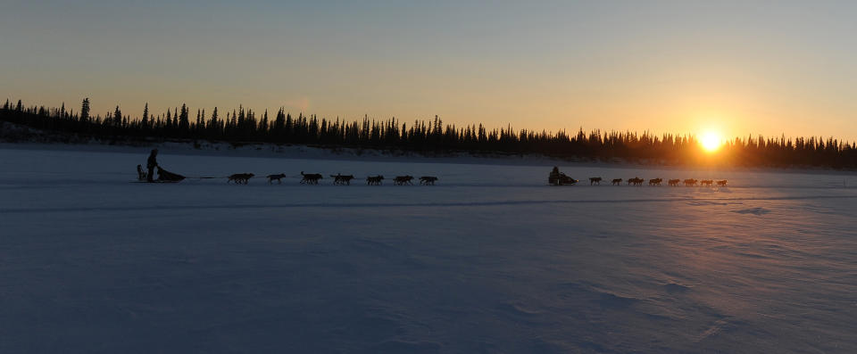 Richie Diehl, from Aniak, AK, and Peter Kaiser, from Bethel, AK, drive their teams down the Yukon River after leaving the Ruby checkpoint during the 2014 Iditarod Trail Sled Dog Race on Friday, March 7, 2014. (AP Photo/The Anchorage Daily News Bob Hallinen)